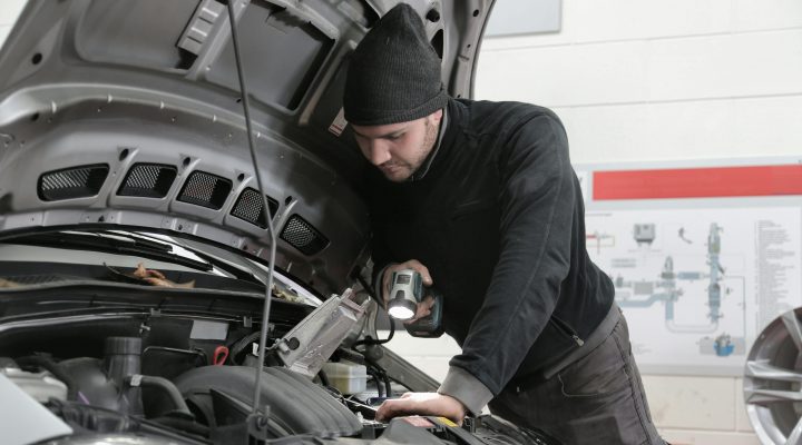 Autostar technician conducting vehicle inspection and mechanical repairs, hood open in their Christchurch workshop.