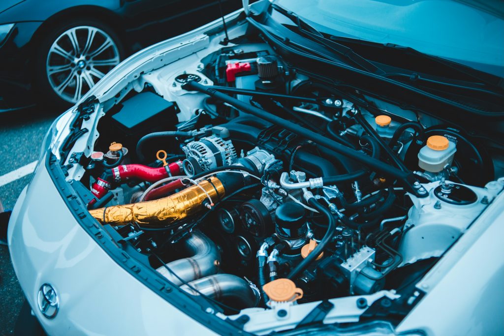 Autostar mechanics inspecting a car engine, ensuring all components are in top condition for a WOF.